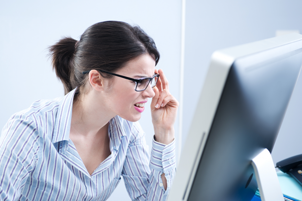 Woman squinting at her computer